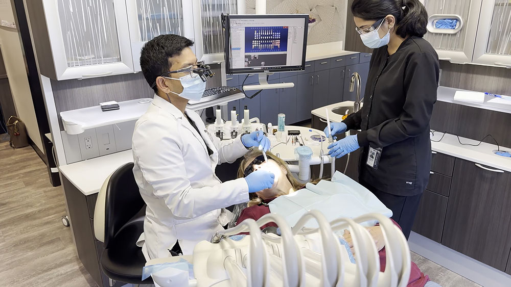 Dentist providing treatment to patient in advanced dental office setting
