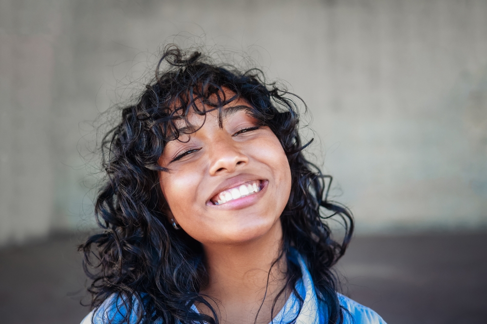 Young woman smiling with bright teeth, representing Laser-Enabled Dentistry results