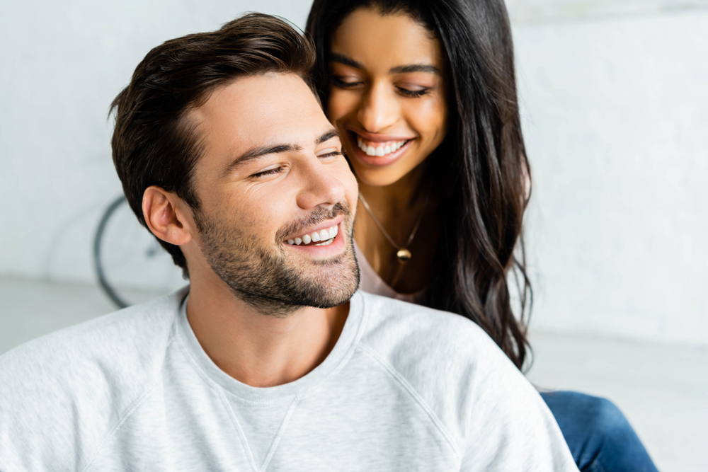 Smiling couple together, representing positive dental experience on Sedation Dentistry and smile confidence