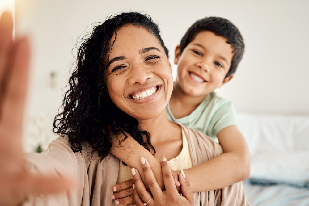 Happy mother and child smiling together, representing family dental care in Bellevue, Seattle and Redmond WA