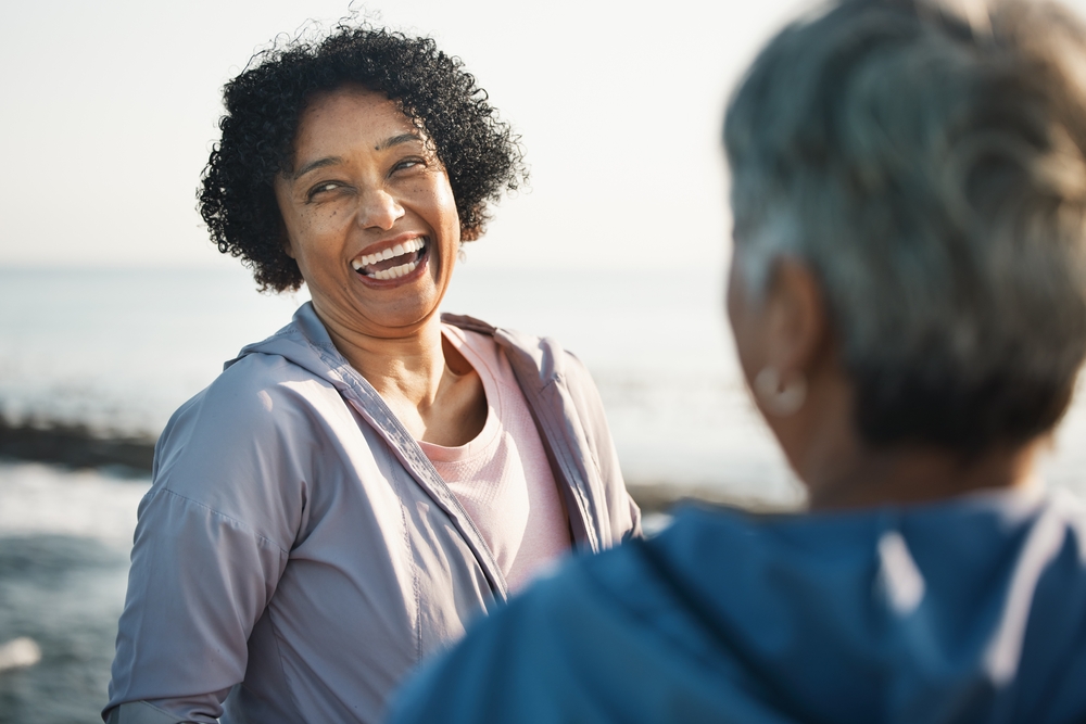 Happy woman smiling during conversation, representing confident smile results after Pinhole procedure