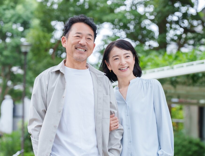 Smiling senior couple outdoors representing happy dental patients in Bellevue, Seattle and Redmond WA