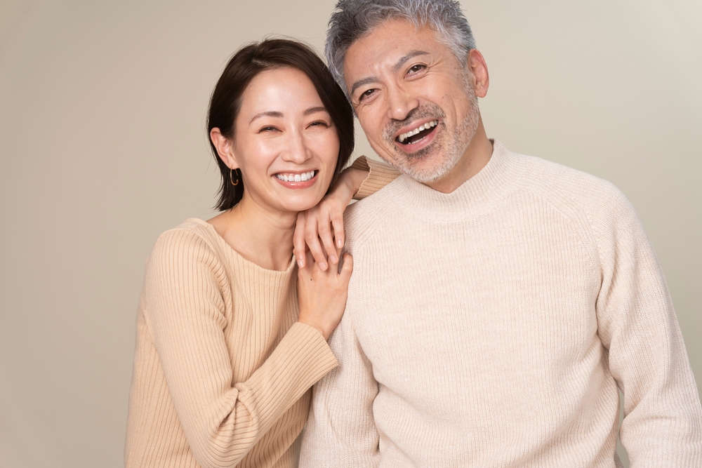 Happy smiling couple embracing, representing positive dental patient experience and confidence