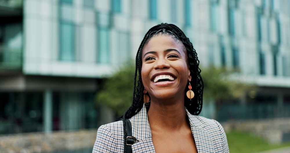 smiling woman on her way to check on her possible dental treatments