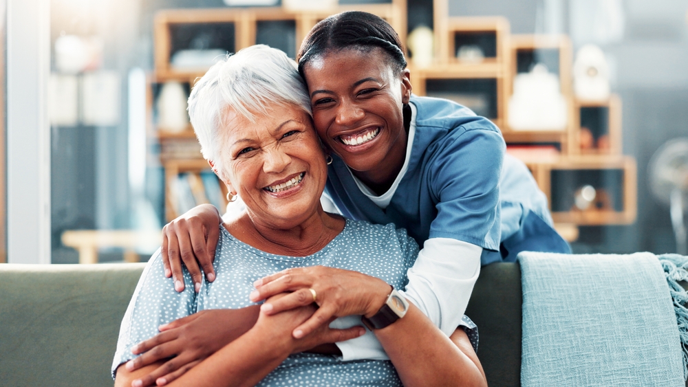 Happy senior woman after laser dentistry with caregiver, representing compassionate family dental care
